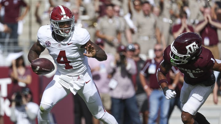 Oct 7, 2023; College Station, Texas, USA; Alabama Crimson Tide quarterback Jalen Milroe (4) scrambles with the ball as Texas A&M Aggies defensive back Bryce Anderson (1) applies defensive pressure during the second quarter at Kyle Field.
