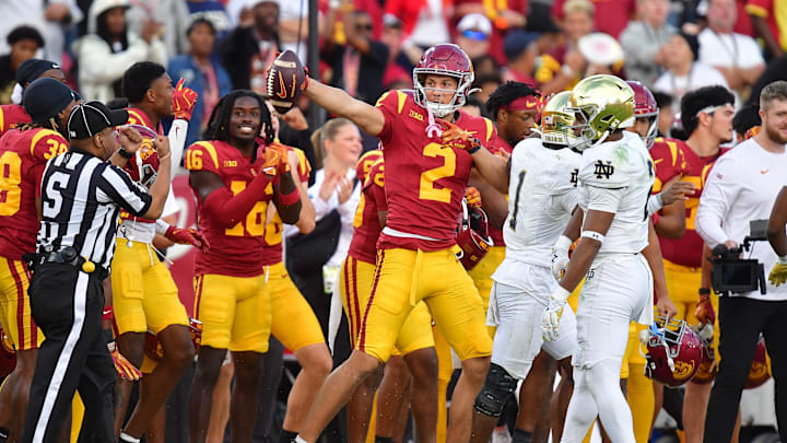 Nov 30, 2024; Los Angeles, California, USA; Southern California Trojans wide receiver Duce Robinson (2) catches a pass against Notre Dame Fighting Irish safety Rod Heard II (2) during the second half at the Los Angeles Memorial Coliseum. Mandatory Credit: Gary A. Vasquez-Imagn Images