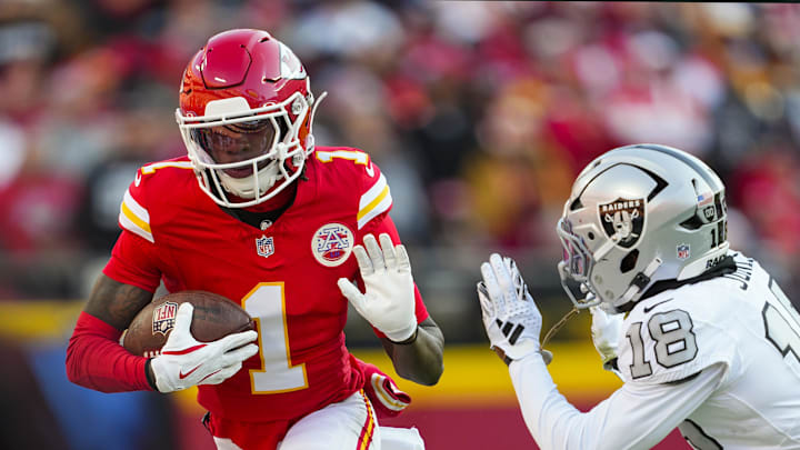 Kansas City Chiefs wide receiver Xavier Worthy (1) runs with the ball against Las Vegas Raiders cornerback Darnay Holmes (30) during the first half at GEHA Field at Arrowhead Stadium. 