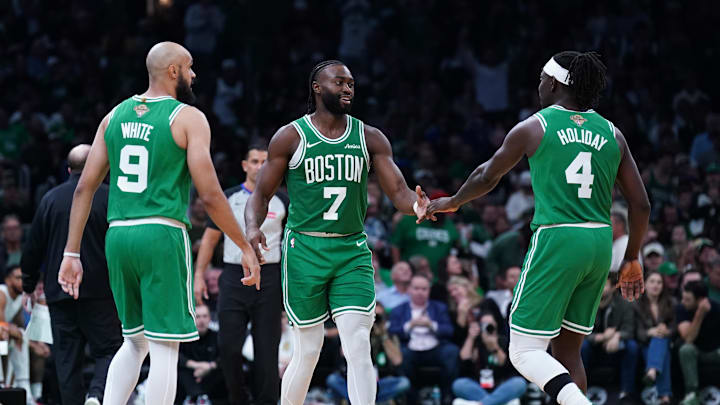 Oct 22, 2024; Boston, Massachusetts, USA; Boston Celtics guard Jaylen Brown (7), guard Jrue Holiday (4) and guard Derrick White (9) react after a play against the New York Knicks in the second half at TD Garden. Mandatory Credit: David Butler II-Imagn Images