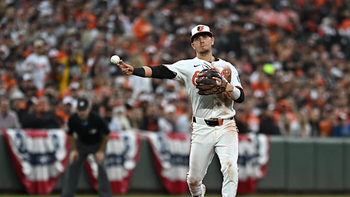Oct 1, 2024; Baltimore, Maryland, USA; Baltimore Orioles third baseman Ramon Urias (29) throws to first base in the eighth inning against the Kansas City Royals in game one of the Wild Card round for the 2024 MLB Playoffs at Oriole Park at Camden Yards. Mandatory Credit: Tommy Gilligan-Imagn Images