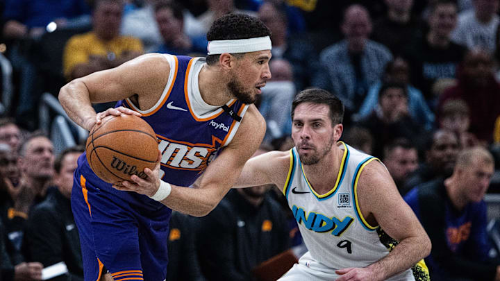 Jan 4, 2025; Indianapolis, Indiana, USA;  Phoenix Suns guard Devin Booker (1) controls the ball against Indiana Pacers guard T.J. McConnell (9) in the second half at Gainbridge Fieldhouse. Mandatory Credit: Trevor Ruszkowski-Imagn Images