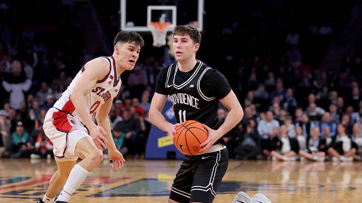 Mar 12, 2026; New York, NY, USA; Providence Friars guard Ryan Mela (11) looks to pass the ball from his knees against St. John's Red Storm guard Dylan Darling (0) during the first half at Madison Square Garden. Mandatory Credit: Brad Penner-Imagn Images