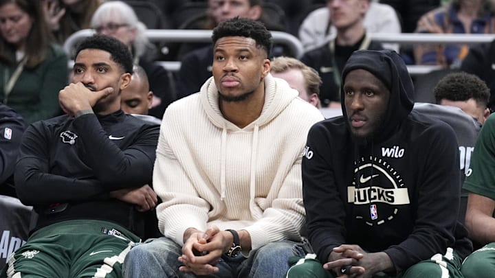 Mar 17, 2026; Milwaukee, Wisconsin, USA; Milwaukee Bucks guard Gary Harris (11), left, Milwaukee Bucks forward Giannis Antetokounmpo (34) and Milwaukee Bucks forward Taurean Prince (12) watch the game against the Cleveland Cavaliers from the bench in the second half at Fiserv Forum. Mandatory Credit: Michael McLoone-Imagn Images