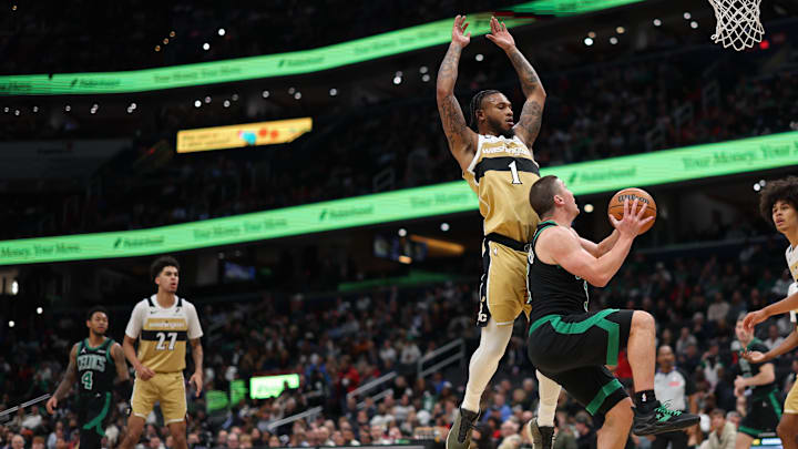 Dec 4, 2025; Washington, District of Columbia, USA; Boston Celtics guard Payton Pritchard (11) drives to the basket as Washington Wizards forward Cam Whitmore (1) defends in the first half at Capital One Arena. Mandatory Credit: Geoff Burke-Imagn Images