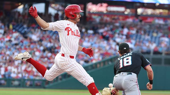 Aug 19, 2026; Philadelphia, Pennsylvania, USA; Philadelphia Phillies catcher Garrett Stubbs (21) beats out the throw to Miami Marlins right fielder Griffin Conine (18) for an RBI single during the second inning at Citizens Bank Park. Mandatory Credit: Bill Streicher-Imagn Images