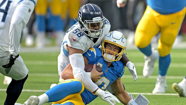 Nov 10, 2024; Inglewood, California, USA;  Los Angeles Chargers quarterback Justin Herbert (10) is stopped by Tennessee Titans linebacker Harold Landry III (58) after a first down in the first half at SoFi Stadium. Mandatory Credit: Jayne Kamin-Oncea-Imagn Images