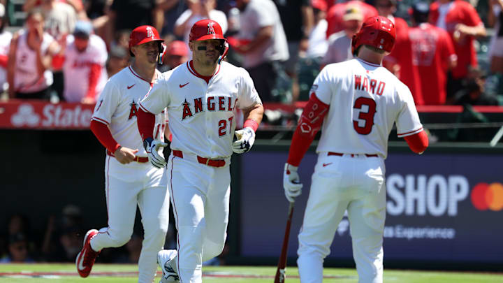 Jul 27, 2025; Anaheim, California, USA;  Los Angeles Angels designated hitter Mike Trout (27) is greeted by left fielder Taylor Ward (3) after hitting a two-run home run for his 1,000th career RBI during the fifth inning against the Seattle Mariners at Angel Stadium. Mandatory Credit: Kiyoshi Mio-Imagn Images