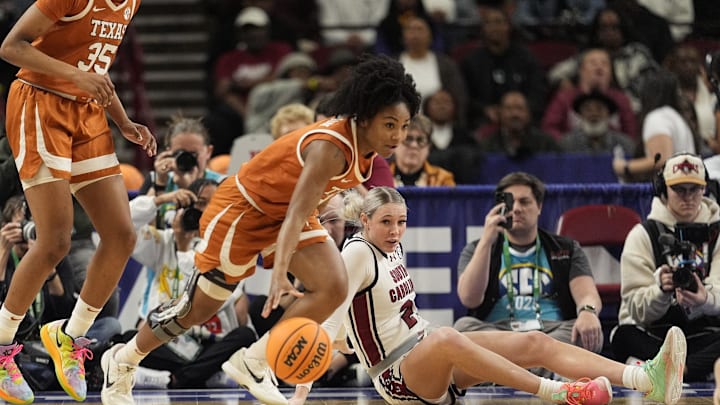 Texas Longhorns guard Rori Harmon (3) grabs a loose ball as South Carolina Gamecocks forward Chloe Kitts (21) watches during the first half at Bon Secours Wellness Arena. Mandatory Credit: Jim Dedmon-Imagn Images