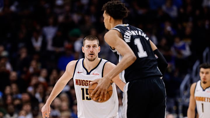 Jan 3, 2025; Denver, Colorado, USA; San Antonio Spurs center Victor Wembanyama (1) controls the ball as Denver Nuggets center Nikola Jokic (15) guards in the third quarter at Ball Arena. Mandatory Credit: Isaiah J. Downing-Imagn Images