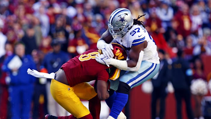 Nov 24, 2024; Landover, Maryland, USA; Washington Commanders running back Brian Robinson Jr. (8) is tackled by Dallas Cowboys defensive tackle Osa Odighizuwa (97) during the second quarter at Northwest Stadium. Mandatory Credit: Peter Casey-Imagn Images Nov 24, 2024; Landover, Maryland, USA; Washington Commanders running back Brian Robinson Jr. (8) is tackled by Dallas Cowboys defensive tackle Osa Odighizuwa (97) during the second quarter at Northwest Stadium. Mandatory Credit: Peter Casey-Imagn Images