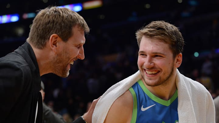 December 1, 2019; Los Angeles, CA, USA; Dallas Mavericks forward Luka Doncic (77) meets with former player Dirk Nowitzki following the 114-100 victory at Staples Center. Mandatory Credit: Gary A. Vasquez-Imagn Images