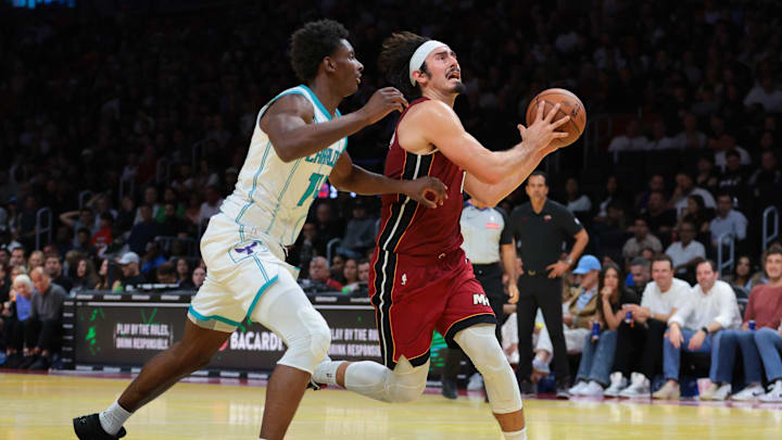 Nov 7, 2025; Miami, Florida, USA; Miami Heat forward Jaime Jaquez Jr. (11) drives to the basket against Charlotte Hornets forward Moussa Diabate (14) during the fourth quarter of an NBA Cup game at Kaseya Center. Mandatory Credit: Sam Navarro-Imagn Images