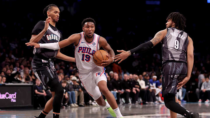 Feb 12, 2025; Brooklyn, New York, USA; Philadelphia 76ers forward Justin Edwards (19) drives to the basket against Brooklyn Nets forwards Ziaire Williams (8) and Trendon Watford (9) during the fourth quarter at Barclays Center. Mandatory Credit: Brad Penner-Imagn Images Feb 12, 2025; Brooklyn, New York, USA; Philadelphia 76ers forward Justin Edwards (19) drives to the basket against Brooklyn Nets forwards Ziaire Williams (8) and Trendon Watford (9) during the fourth quarter at Barclays Center. Mandatory Credit: Brad Penner-Imagn Images