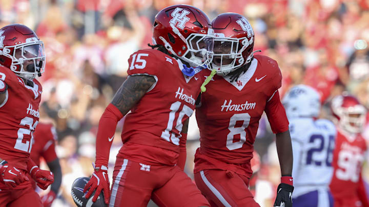 Nov 22, 2025; Houston, Texas, USA; Houston Cougars defensive back Will James (15) celebrates with defensive back Kentrell Webb (8) after an interception during the second quarter against the TCU Horned Frogs at TDECU Stadium. Mandatory Credit: Troy Taormina-Imagn Images