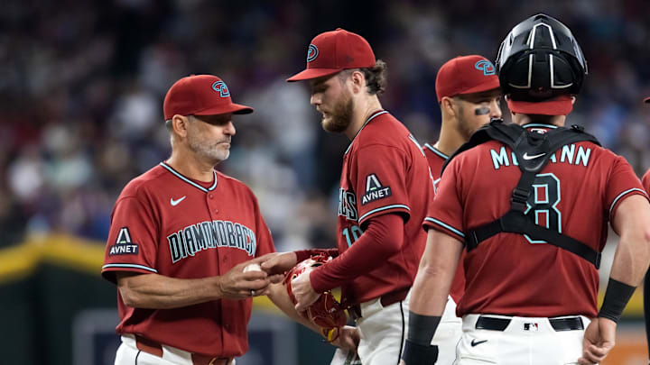 Apr 19, 2026; Phoenix, Arizona, USA; Arizona Diamondbacks manager Torey Lovullo (left) pulls pitcher Ryne Nelson from the game in the first inning against the Toronto Blue Jays at Chase Field. Mandatory Credit: Mark J. Rebilas-Imagn Images
