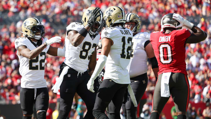 Dec 31, 2023; Tampa, Florida, USA;  New Orleans Saints tight end Juwan Johnson (83) is congratulated by wide receiver Chris Olave (12) after scoring a touchdown against the Tampa Bay Buccaneers in the first quarter at Raymond James Stadium. Mandatory Credit: Nathan Ray Seebeck-USA TODAY Sports