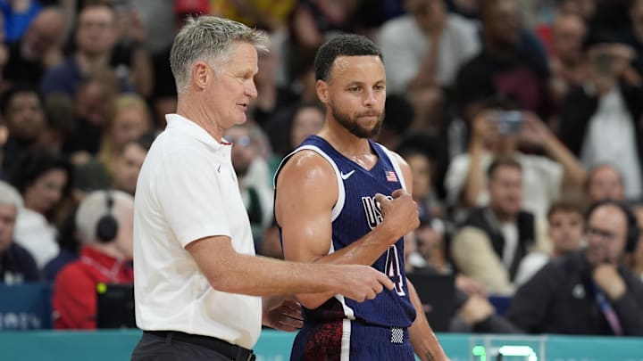 United States head coach Steve Kerr talks to shooting guard Stephen Curry.