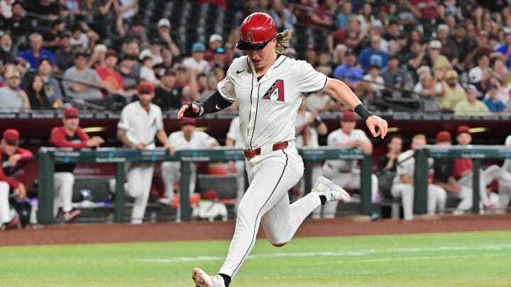 Jul 31, 2024; Phoenix, Arizona, USA;  Arizona Diamondbacks outfielder Jake McCarthy (31) scores against the Washington Nationals in the third inning at Chase Field. Mandatory Credit: Matt Kartozian-USA TODAY Sports