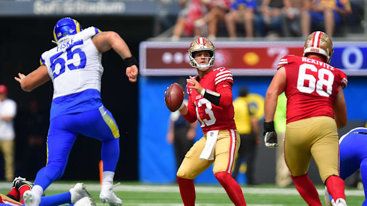 Sep 22, 2024; Inglewood, California, USA; San Francisco 49ers quarterback Brock Purdy (13) drops back to pass as Los Angeles Rams defensive tackle Braden Fiske (55) moves in during the first half at SoFi Stadium. Mandatory Credit: Gary A. Vasquez-Imagn Images