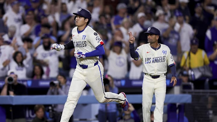 Jun 14, 2025; Los Angeles, California, USA;  Los Angeles Dodgers designated hitter Shohei Ohtani, left, celebrates with third base coach Dino Ebel after hitting a solo home-run during the sixth inning of a baseball game against the San Francisco Giants at Dodger Stadium. Mandatory Credit: Ryan Sun-Imagn Images
