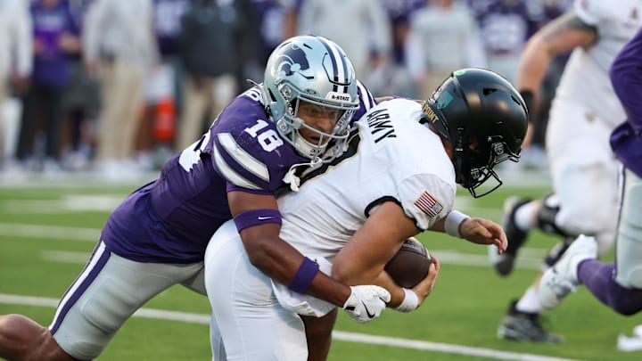 Sep 6, 2025; Manhattan, Kansas, USA; Kansas State Wildcats safety Wesley Fair (18) tackles Army Black Knights quarterback Cale Hellums (3) during the third quarter at Bill Snyder Family Football Stadium. Mandatory Credit: Scott Sewell-Imagn Images