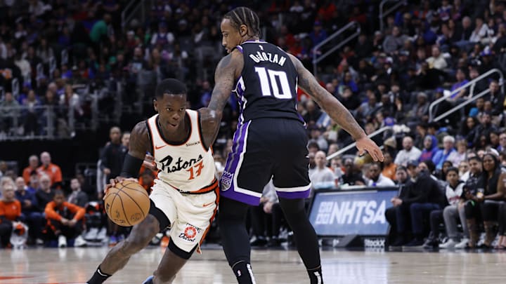 Apr 7, 2025; Detroit, Michigan, USA;  Detroit Pistons guard Dennis Schroder (17) dribbles on Sacramento Kings forward DeMar DeRozan (10) in the second half at Little Caesars Arena. Mandatory Credit: Rick Osentoski-Imagn Images