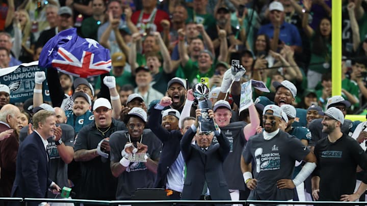 Philadelphia Eagles owner Jeffrey Lurie hoists the Vince Lombardi Trophy after defeating the Kansas City Chiefs in Super Bowl LIX.