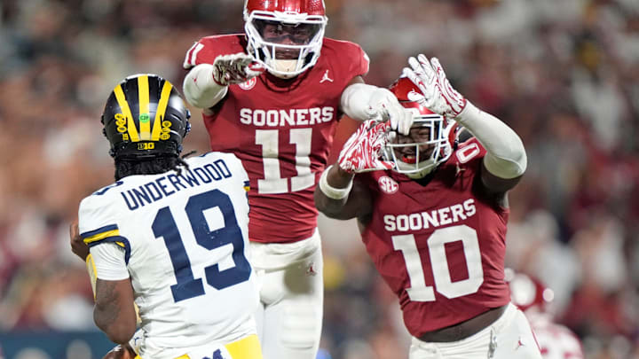 Oklahoma's Kobie McKinzie (11) and Kip Lewis (10) pressure Michigan's Bryce Underwood (19)