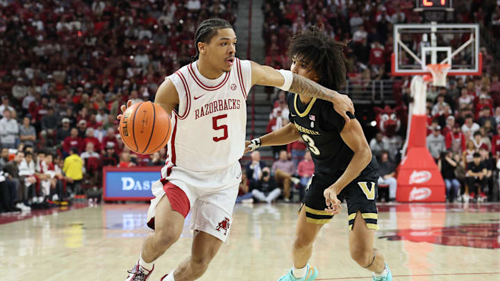 Jan 20, 2026; Fayetteville, Arkansas, USA; Arkansas Razorbacks guard Darius Acuff Jr (5) drives against Vanderbilt Commodores guard Tyler Tanner (3) during the first half against at Bud Walton Arena. Mandatory Credit: Nelson Chenault-Imagn Images