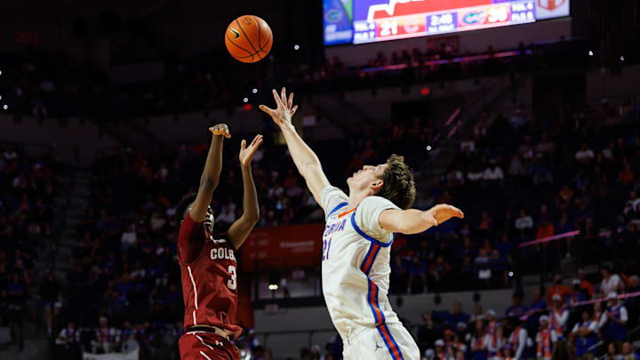 Dec 21, 2025; Gainesville, Florida, USA; Colgate Raiders guard Jalen Cox (3) shoots over Florida Gators forward Alex Condon (21) during the first half at Exactech Arena at the Stephen C. O'Connell Center. Mandatory Credit: Matt Pendleton-Imagn Images