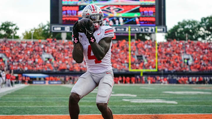 Ohio State Buckeyes wide receiver Jeremiah Smith (4) catches a touchdown pass during the second half of the NCAA football game against the Illinois Fighting Illini at Gies Memorial Stadium in Champaign on Oct. 11, 2025. Ohio State won 34-16.