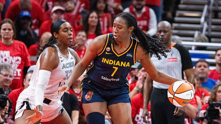 Sep 29, 2026; Indianapolis, Indiana, USA;  Indiana Fever center Aliyah Boston (7) dribbles the ball while Las Vegas Aces forward Cheyenne Parker-Tyus (32) defends during game two of the first round for the 2026 WNBA Playoffs at Gainbridge Fieldhouse.  Mandatory Credit: Trevor Ruszkowski-Imagn Images