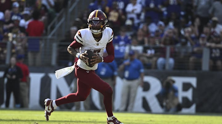 Oct 13, 2024; Baltimore, Maryland, USA;  Washington Commanders quarterback Jayden Daniels (5) rolls out to pass during the second half against the Baltimore Ravens at M&T Bank Stadium. Mandatory Credit: Tommy Gilligan-Imagn Images