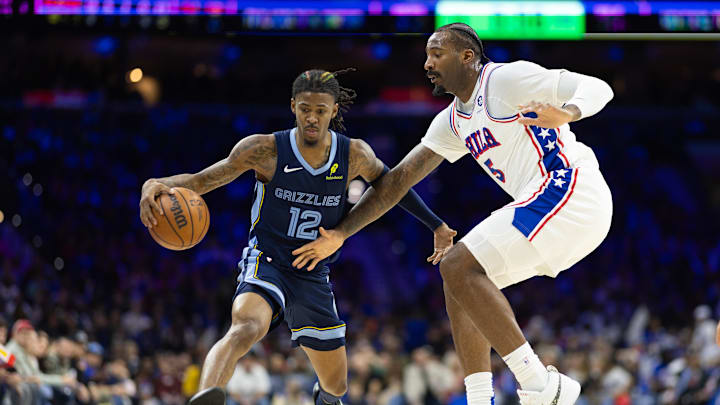 Nov 2, 2024; Philadelphia, Pennsylvania, USA; Memphis Grizzlies guard Ja Morant (12) dribbles the ball against Philadelphia 76ers center Andre Drummond (5) during the third quarter at Wells Fargo Center. Mandatory Credit: Bill Streicher-Imagn Images