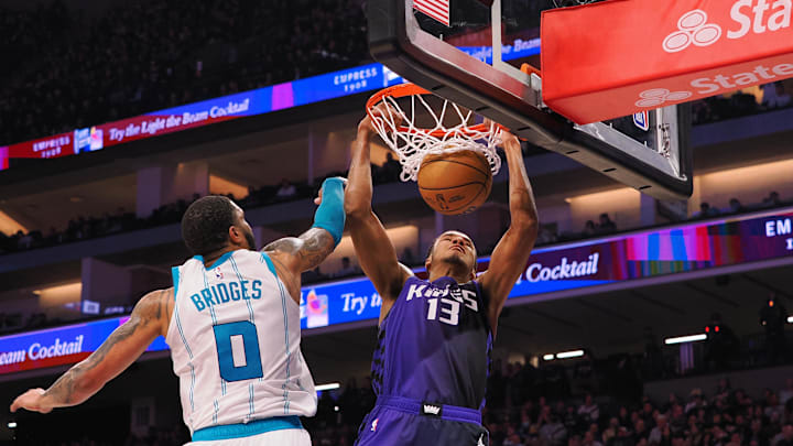Jan 2, 2024; Sacramento, California, USA; Sacramento Kings forward Keegan Murray (13) dunks the ball against Charlotte Hornets forward Miles Bridges (0) during the second quarter at Golden 1 Center. Mandatory Credit: Kelley L Cox-Imagn Images