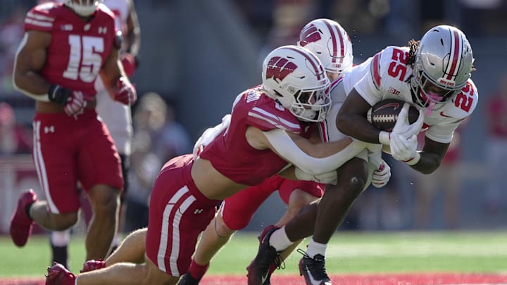 Oct 18, 2025; Madison, Wisconsin, USA; Wisconsin Badgers linebacker Christian Alliegro (0) tackles Ohio State Buckeyes running back Bo Jackson (25) in the first quarter at Camp Randall Stadium. Mandatory Credit: Jeff Hanisch-Imagn Images Oct 18, 2025; Madison, Wisconsin, USA; Wisconsin Badgers linebacker Christian Alliegro (0) tackles Ohio State Buckeyes running back Bo Jackson (25) in the first quarter at Camp Randall Stadium. Mandatory Credit: Jeff Hanisch-Imagn Images