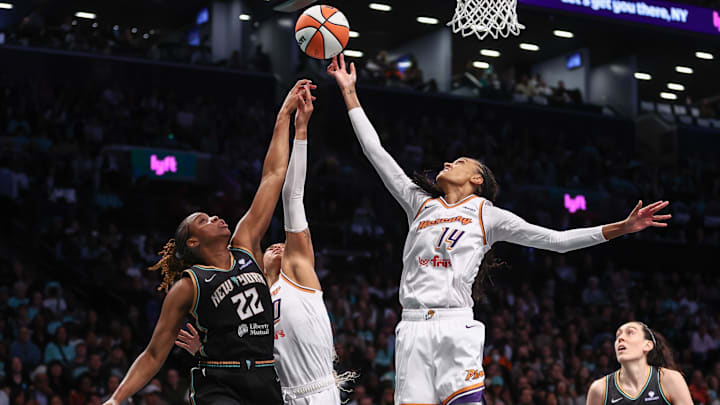 Sep 17, 2025; Brooklyn, New York, USA; New York Liberty forward Kennedy Burke (22) and Phoenix Mercury forward DeWanna Bonner (14) fight for a rebound during game two of round one for the 2025 WNBA Playoffs at Barclays Center. Mandatory Credit: Wendell Cruz-Imagn Images