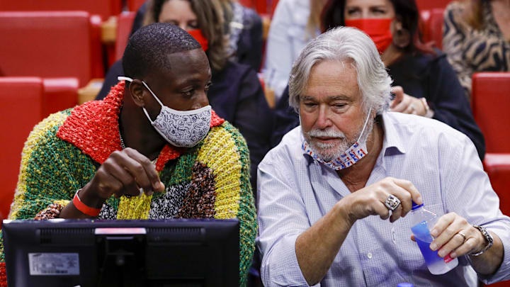 Nov 18, 2021; Miami, Florida, USA; Former Miami Heat player Dwyane Wade talks to Miami Heat owner Micky Arison during the game against the Washington Wizards at FTX Arena. Mandatory Credit: Sam Navarro-Imagn Images