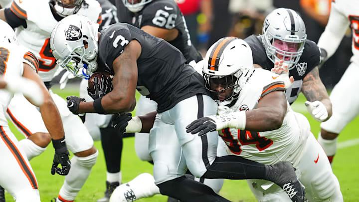 Sep 29, 2024; Paradise, Nevada, USA; Las Vegas Raiders running back Zamir White (3) is tackled by Cleveland Browns defensive tackle Dalvin Tomlinson (94) during the first quarter at Allegiant Stadium. Mandatory Credit: Stephen R. Sylvanie-Imagn Images
