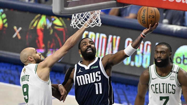 Jun 12, 2024; Dallas, Texas, USA; Dallas Mavericks guard Kyrie Irving (11) shoots against Boston Celtics guard Derrick White (9) during the third quarter in game three of the 2024 NBA Finals at American Airlines Center. Mandatory Credit: Jerome Miron-USA TODAY Sports