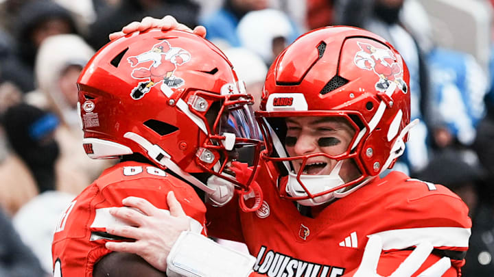 Louisville Cardinals tight end Jaleel Skinner (88) hugs Louisville Cardinals quarterback Miller Moss (7) after scoring a touchdown pass in the second half as the Cards dominated Kentucky 41-0 Saturday, November 29, 2025 in Louisville, Kentucky at L&N Federal Credit Union Stadium.