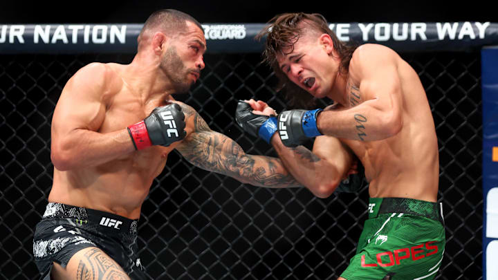 Jun 29, 2024; Las Vegas, Nevada, USA; Dan Ige (red gloves) fights Diego Lopes (blue gloves) during UFC 303 at T-Mobile Arena. Mandatory Credit: Mark J. Rebilas-USA TODAY Sports