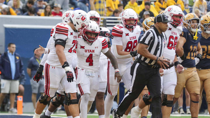 Utah Utes quarterback Devon Dampier (4) celebrates with teammates after throwing for a touchdown during the second quarter against the West Virginia Mountaineers at Milan Puskar Stadium. Utah Utes quarterback Devon Dampier (4) celebrates with teammates after throwing for a touchdown during the second quarter against the West Virginia Mountaineers at Milan Puskar Stadium.