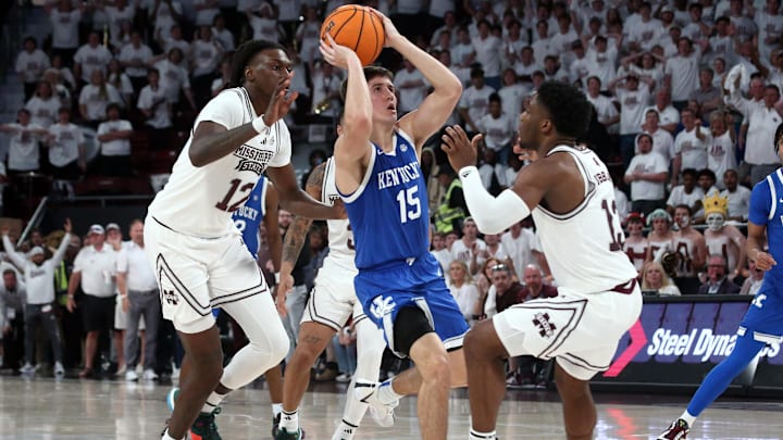 Feb 27, 2024; Starkville, Mississippi, USA; Kentucky Wildcats guard Reed Sheppard (15) scores on the final shot of the game as Mississippi State Bulldogs forward KeShawn Murphy (12) and guard Josh Hubbard (13) defend during the second half at Humphrey Coliseum. Mandatory Credit: Petre Thomas-Imagn Images