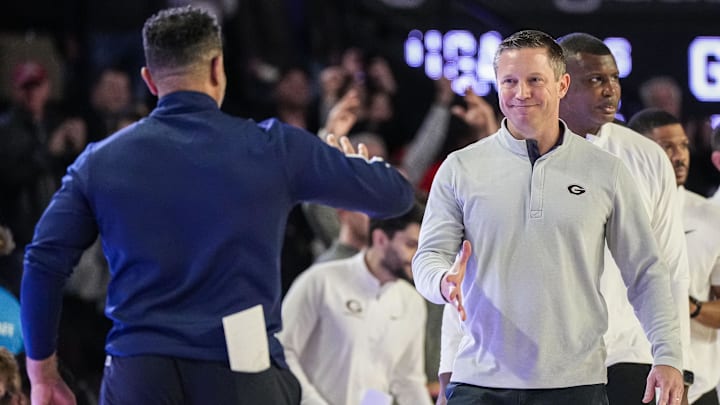 Dec 5, 2023; Athens, Georgia, USA; Georgia Bulldogs head coach Mike White (right) extends his hand to Georgia Tech Yellow Jackets head coach Damon Stoudamire after Georgia defeated Georgia Tech at Stegeman Coliseum. Mandatory Credit: Dale Zanine-Imagn Images Dec 5, 2023; Athens, Georgia, USA; Georgia Bulldogs head coach Mike White (right) extends his hand to Georgia Tech Yellow Jackets head coach Damon Stoudamire after Georgia defeated Georgia Tech at Stegeman Coliseum. Mandatory Credit: Dale Zanine-Imagn Images