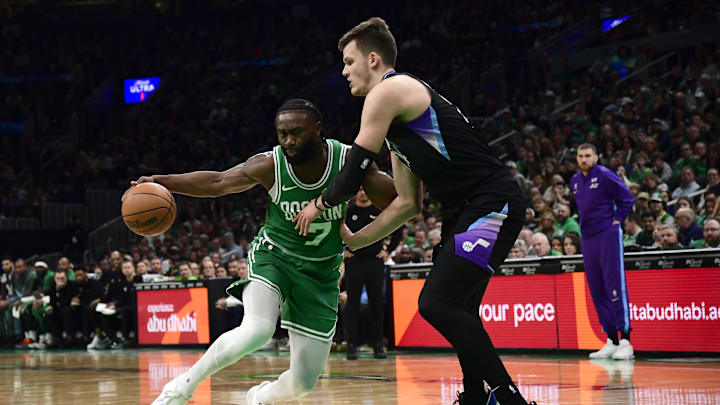 Mar 10, 2025; Boston, Massachusetts, USA;  Boston Celtics guard Jaylen Brown (7) controls the ball while Utah Jazz center Walker Kessler (24) defends during the first half at TD Garden. Mandatory Credit: Bob DeChiara-Imagn Images