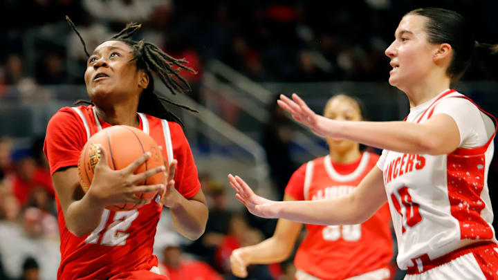 Aliquippa guard Aunesty Johnson drove toward the rim past Neshannock's Nina Medure during the first half of the WPIAL Class 2A girls basketball game Saturday at Petersen Events Center. Johnson finished with 17 points and 11 rebounds as the Quips picked up a 54-51 to win their first WPIAL title since 1990.