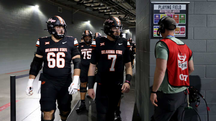 Oklahoma State's Joe Michalski (66) and Alan Bowman (7) walk to the field for warm ups before the Big 12 Football Championship game between the Oklahoma State University Cowboys and the Texas Longhorns at the AT&T Stadium in Arlington, Texas, Saturday, Dec. 2, 2023. Oklahoma State's Joe Michalski (66) and Alan Bowman (7) walk to the field for warm ups before the Big 12 Football Championship game between the Oklahoma State University Cowboys and the Texas Longhorns at the AT&T Stadium in Arlington, Texas, Saturday, Dec. 2, 2023.