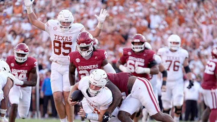 Texas Longhorns quarterback Quinn Ewers (3) scores a touchdown as Oklahoma Sooners defensive back Robert Spears-Jennings (3) defends in the second half following the Red River Rivalry college football game between the University of Oklahoma Sooners and the Texas Longhorn at the Cotton Bowl Stadium in Dallas, Texas, Saturday, Oct., 12, 2024.